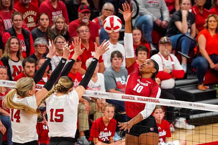 Oct 21, 2023; Lincoln, NE, USA; Wisconsin Badgers middle blocker Devyn Robinson (10) attacks against Nebraska Cornhuskers outside hitter Ally Batenhorst (14) and middle blocker Andi Jackson (15) during the second set. Mandatory Credit: Dylan Widger-USA TODAY Sports
